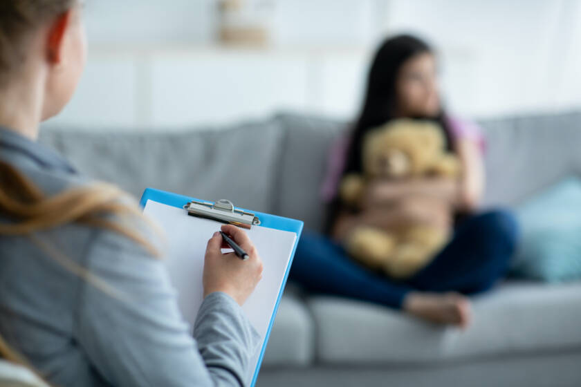 Therapist talking to teen girl about her depression.