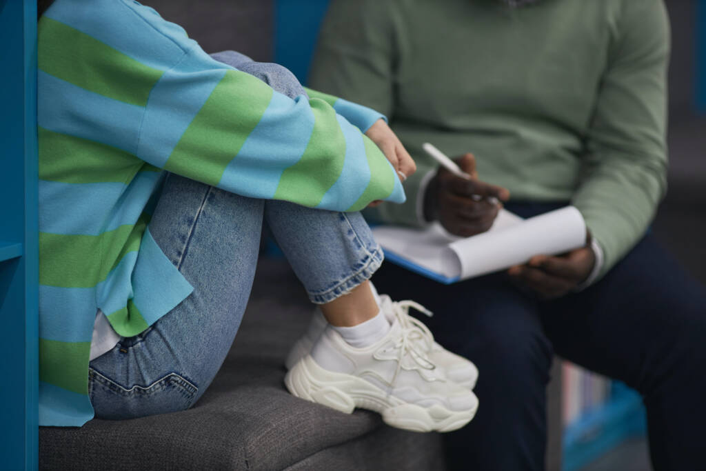 Stressed teenager talking with therapist