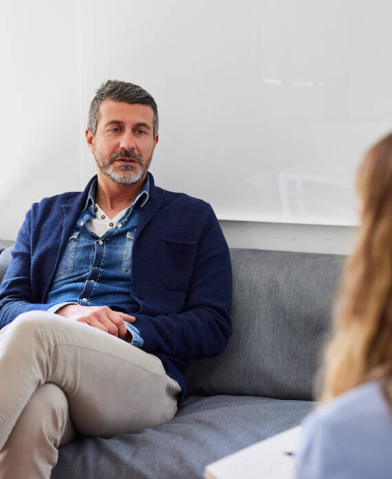 Man sharing his problems with psychologist during therapy session